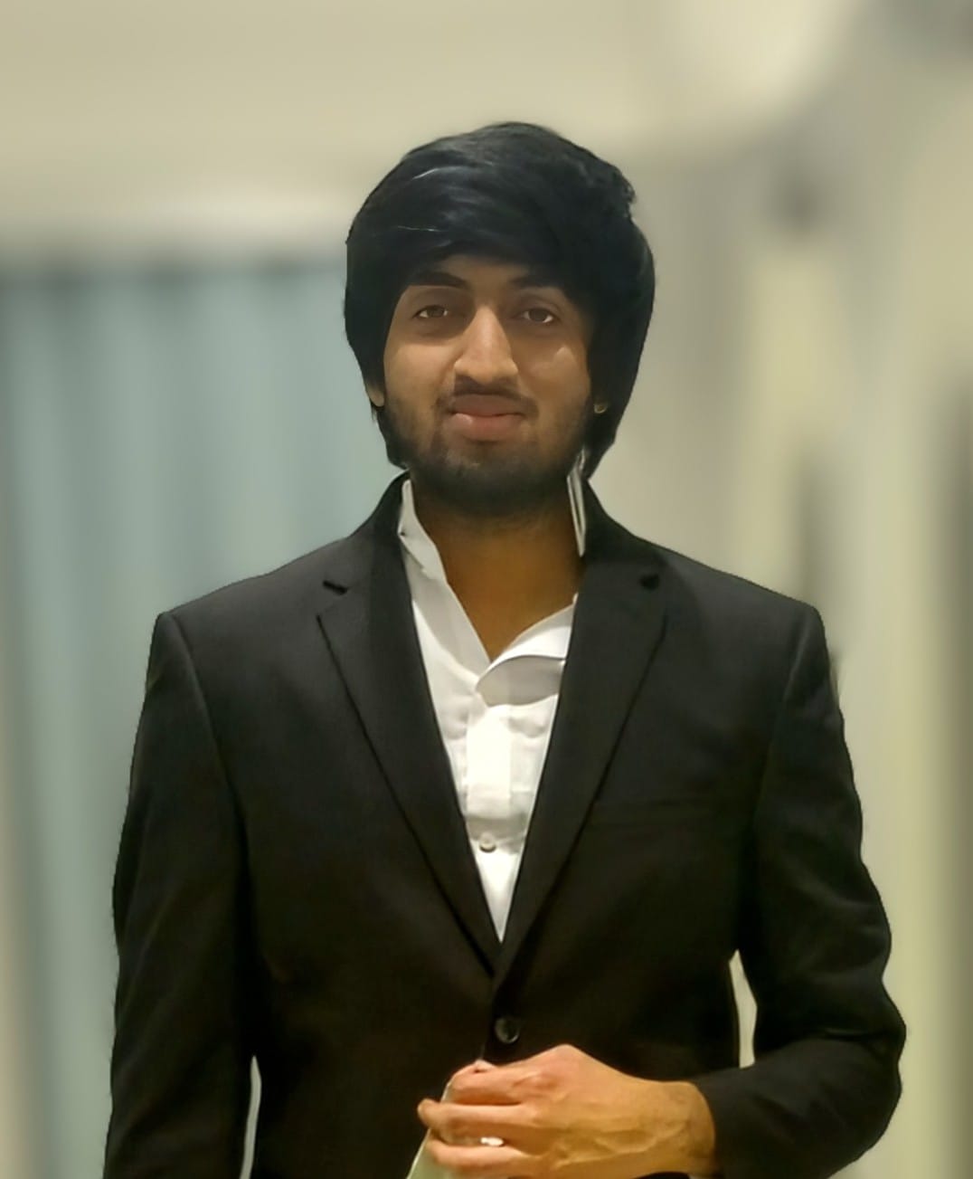 man with black hair and a suit